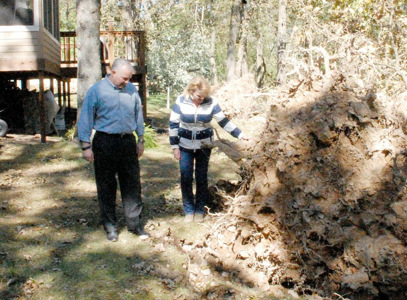 Marc Hayot/Herald-Leader Lt. Gov. Tim Griffin (left) and state Rep. Robin Lundstrom (R-District 87) inspect a downed tree at the 3200 block of S. White Oak Street.