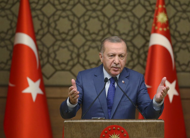 Turkish President Recep Tayyip Erdogan speaks during a meeting at his presidential palace, in Ankara, Turkey, Thursday, Oct. 24, 2019. Erdogan on Thursday renewed a threat to resume its military offensive if his country continued to be "harassed" by the Kurdish militia. (Presidential Press Service via AP, Pool)