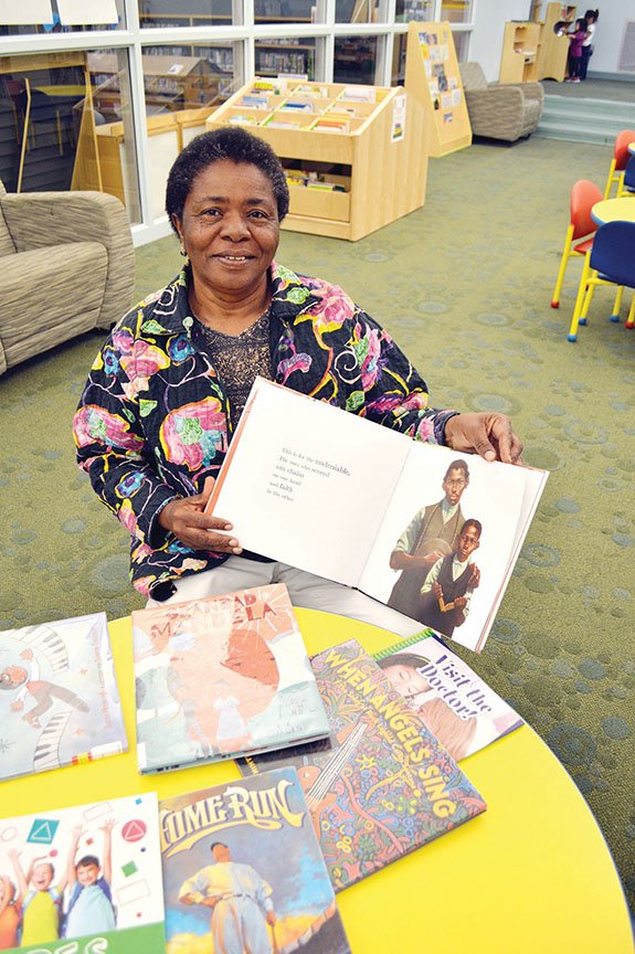 Rene Henderson sits in the children’s section of the Faulkner County Library in Conway. Henderson, a retired nurse and community activist, started a Reading-Buddy program in the Mayflower School District after she heard that test scores were lagging. She also received the Humanitarian Award this month from the Faulkner County Unit of Church Women United.