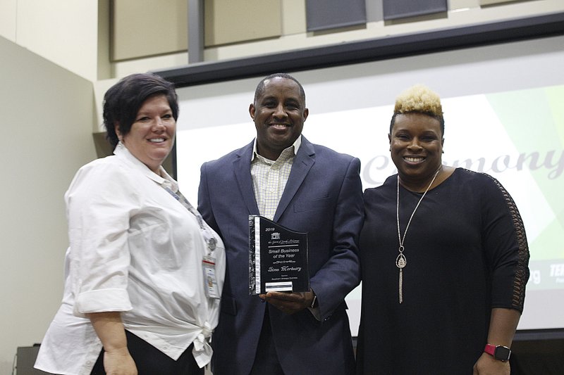 Robert and Natashia Henderson, right, owners of Sims Mortuary, accept the Spirit of South Arkansas Small Business of the Year award from Tawnya Cape, manager of stations - Gulf region for Southern Airways Express. The Spirit of South Arkansas Small Business Awards were held at the El Dorado Conference Center Wednesday evening. 