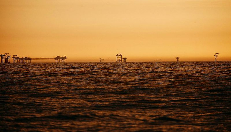 Oil and gas platforms clutter the horizon in the Gulf of Mexico south of Port Fourchon, La., in January 2018. Thanks to a poorly written provision by federal lawmakers in 1995, some of the world’s largest oil companies have avoided paying at least $18 billion in royalties for fuels extracted in the Gulf since 1996. 