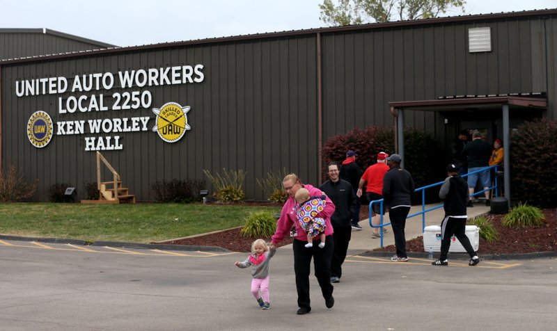 United Auto Worker Lindsey Higgins, exits the the UAW Local 2250 Ken Worley Hall with her two children after voting on the offer made to union workers by General Motors on Thursday, Oct. 24, 2019, in Wentzville, Mo. "I don't feel great about the contract but I have these two to think about. I can't keep striking. I've got to keep a roof over their head," said Higgins. UAW workers have been on strike since Sept. 16. (Laurie Skrivan/St. Louis Post-Dispatch via AP)

