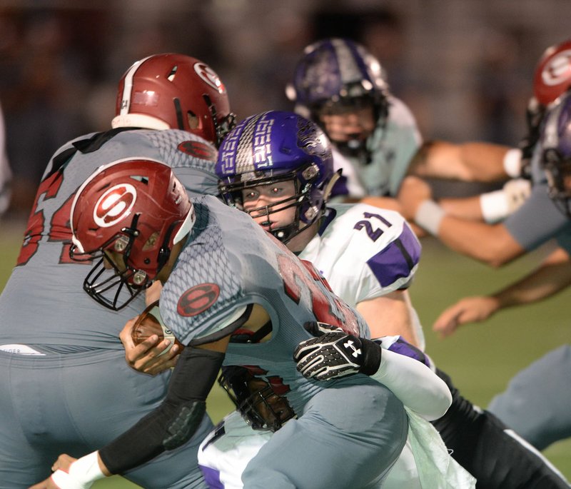 NWA Democrat-Gazette/ANDY SHUPE Springdale running back Gilberto Dominguez (left) is brought down Friday, Oct. 25, 2019, by Fayetteville defender Kaiden Turner (21) during the first half of play at Jarrell Williams Bulldog Stadium in Springdale. Visit nwadg.com/photos to see more photographs from the game.