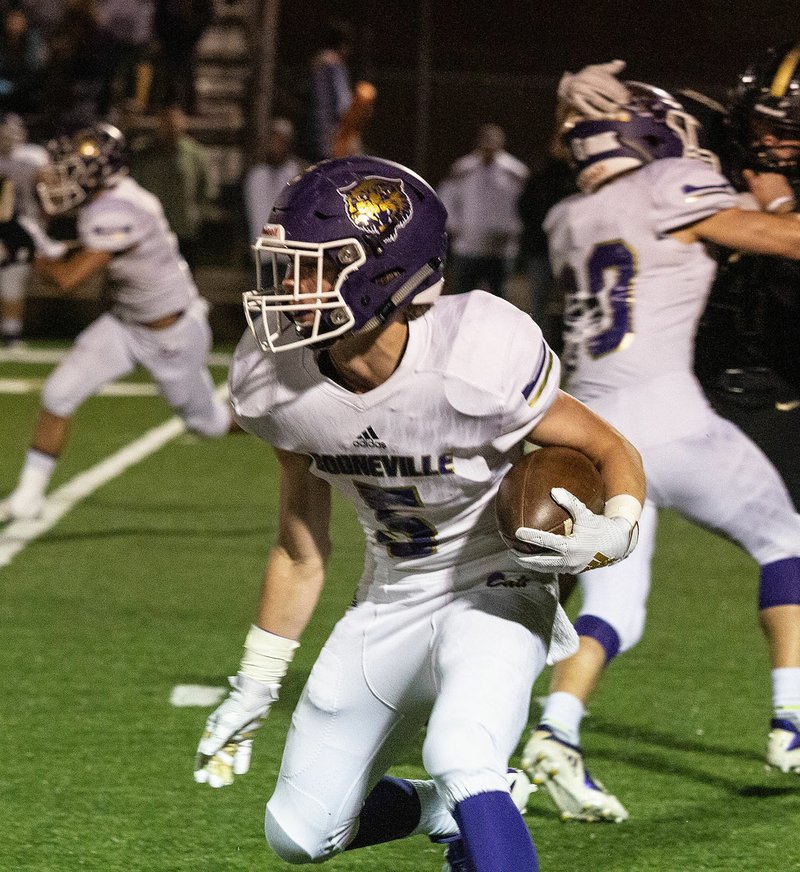 Booneville's Gabe Fennell looks for running room in the first half of Friday's game at Charleston.