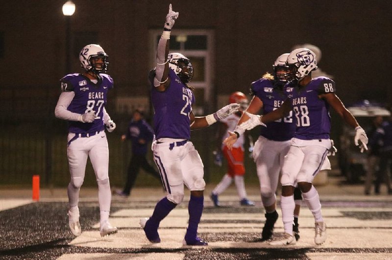 Central Arkansas running back Carlos Blackman (left) celebrates his 28-yard touchdown catch with teammates during the fourth quarter of the Bears’ 29-25 victory over Sam Houston State on Saturday at Estes Stadium in Conway.