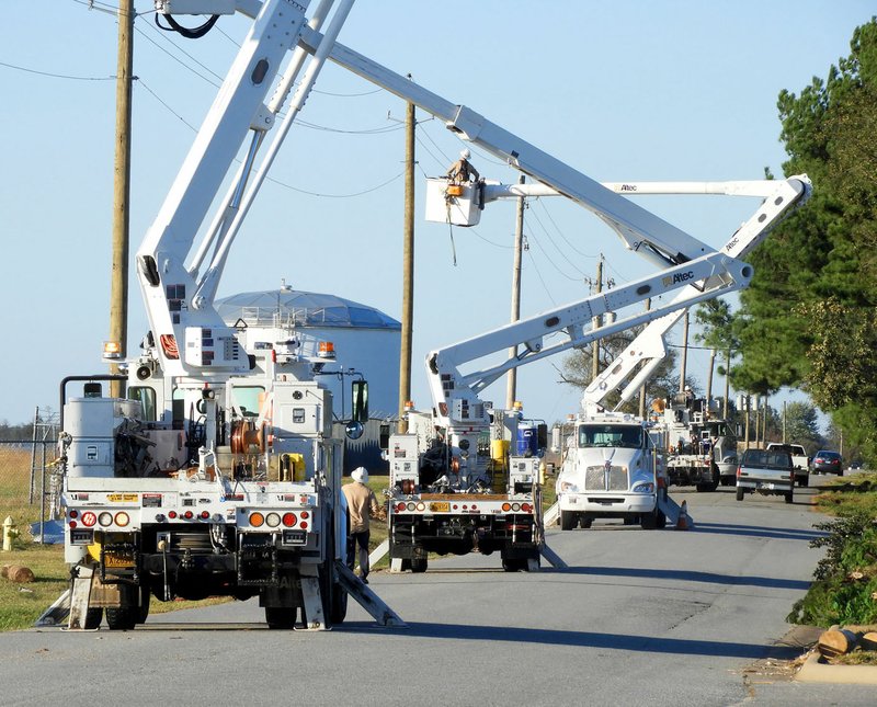 Paul Bonney/Special to Siloam Sunday Electric crews from Arkansas, Oklahoma and Missouri worked to restore power to Siloam Springs after two tornadoes and high winds hit on Oct. 21.