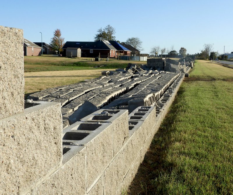 Paul Bonney/Special to the Herald-Leader High winds and a tornado toppled a wall at the Stonecrest Subdivision east of Siloam Springs.