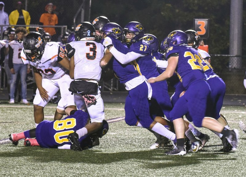 The Sentinel-Record/Grace Brown DEFENSIVE CHARGE: Fountain Lake's Steven DeArmon leads a charge of Cobras against Malvern quarterback Cedric Simmons (3) during Friday's game at Fountain Lake. The Leopards won, 41-16.
