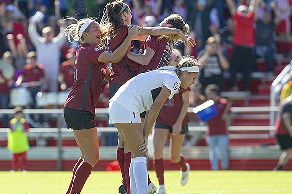 Arkansas' Taylor Malham (middle) celebrates with teammates after scoring a goal in the 85th minute of the Razorbacks' game against Georgia on Sunday, Oct. 27, 2019, in Fayetteville. 