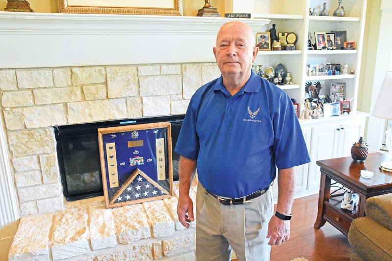 Retired Air Force Col. Donald Harrison Stokes Jr. of Hot Springs Village will be inducted into the Arkansas Military Veterans’ Hall of Fame on Saturday. Stokes, who served a total of 38 years in the military, shows his awards that have been framed in a shadowbox. The American flag included in his display of medals was flown over the U.S. Capitol and presented to Stokes when he retired.