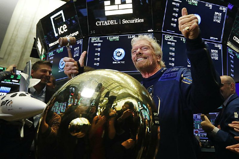 Richard Branson, founder of the space tourism company Virgin Galactic, which began trading Monday on the New York Stock Exchange, celebrates after ringing a ceremonial bell on the exchange floor. The S&P 500 closed at 3,039.42 on Monday, breaking a record set in July.