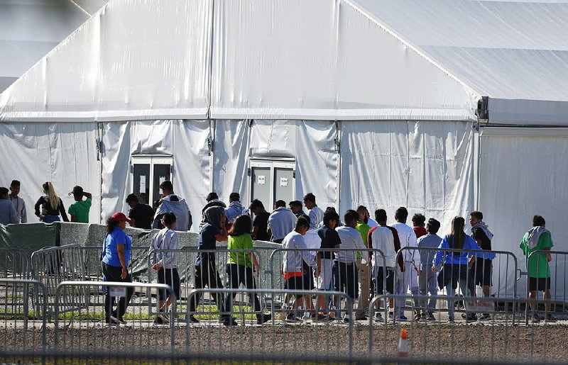 Children line up to enter a tent earlier this year at the detention center in Homestead, Fla. The facility has not accepted new mi- grant children since July 3.
