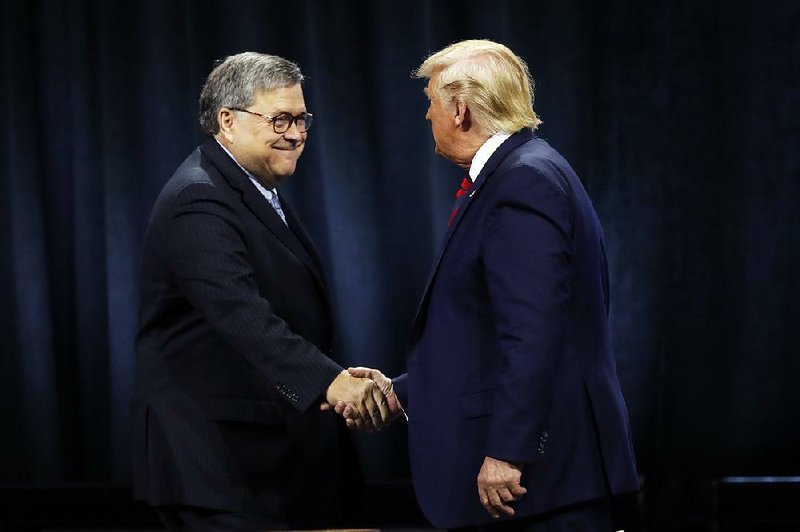 President Donald Trump shakes hands with Attorney General William Barr on Monday at the International Association of Chiefs of Police meeting in Chicago.
