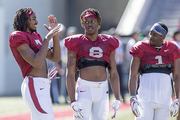 Arkansas receivers Trey Knox (left), Mike Woods (center) and De'Vion Warren are shown during practice Saturday, March 9, 2019, in Fayetteville.