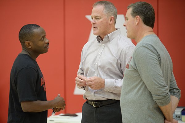 Earl Boykins (from left), Arkansas director of student-athlete development, speaks Thursday, Sept. 26, 2019, with Hunter Yurachek, director of athletics, and assistant coach Clay Mosier during practice in the Eddie Sutton Gymnasium inside the Basketball Performance Center in Fayetteville.