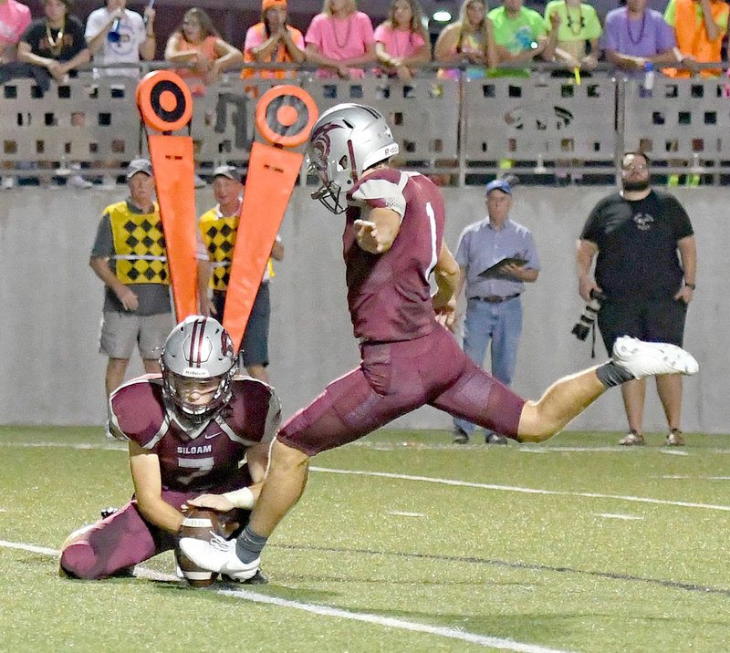 Bud Sullins/Special to the Herald-Leader Siloam Springs senior Harry Losh boosts an extra point after a Siloam Springs touchdown during a game earlier this season. Losh is raising money to help pay for students' negative lunch balances in the Siloam Springs School District.