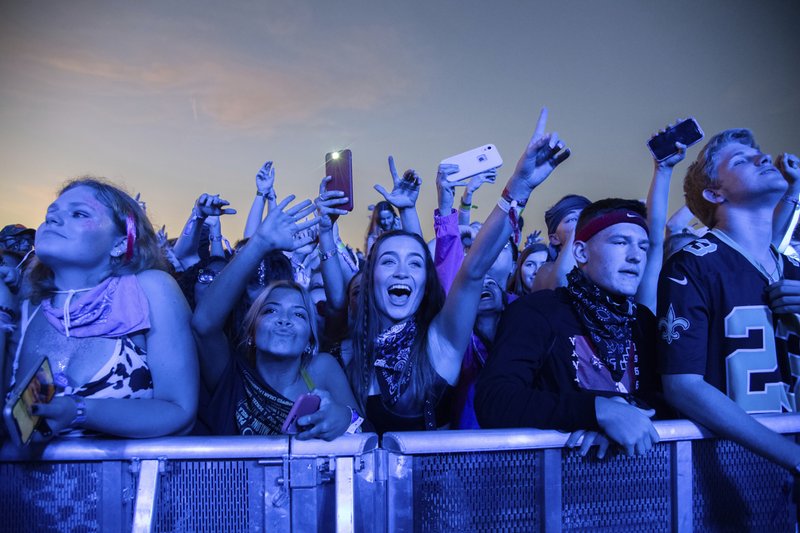 FILE - In this Sunday, Oct. 27, 2019, file photo, festival-goers attend the Voodoo Music Experience in City Park in New Orleans. Major concert promoters in the U.S. are stepping back from plans to scan festival-goers with facial recognition technology, at least for the time being. (Photo by Amy Harris/Invision/AP, File)