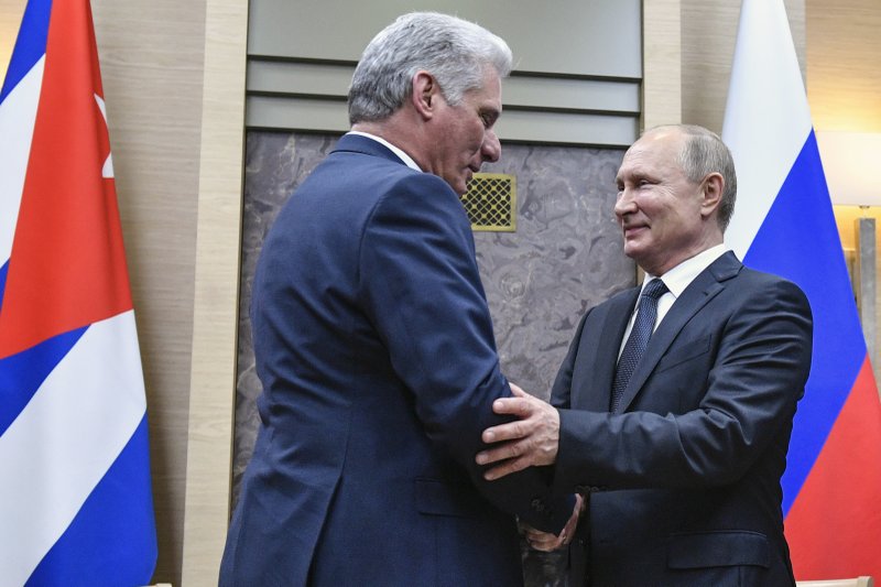 Russian President Vladimir Putin, right, and Cuban President Miguel Diaz-Canel shake hands during their meeting at the Novo-Ogaryovo residence outside Moscow, Russia, Tuesday, Oct. 29, 2019. Putin hailed Cuba's resilience in the face of the U.S. pressure as he hosted Diaz-Canel for talks on expanding cooperation between the old allies. (Alexander Nemenov/Pool Photo via AP)