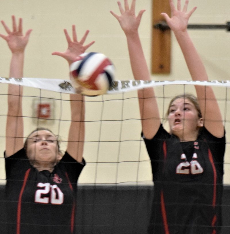 RICK PECK/SPECIAL TO MCDONALD COUNTY PRESS McDonald County's Rylee Bradley (left) and Sydnie Sanny team up for a block during the Lady Mustangs' 25-0, 25-8 loss to Carthage in the Missouri Class 4 District 11 Volleyball Tournament on Oct. 28 at Neosho High School.