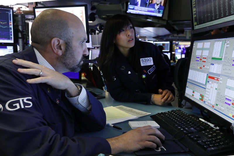 Specialists James Denaro and Erica Fredrickson work on the floor of the New York Stock Exchange, Wednesday, Oct. 30, 2019. Stocks are slipping in early trading on Wall Street as traders hold back ahead of an interest rate announcement from the Federal Reserve. (AP Photo/Richard Drew)