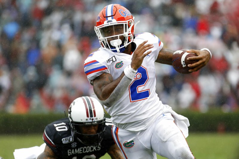 Florida's Lamichal Perine (2) runs away from South Carolina's R.J. Roderick (10) in the second half of an NCAA college football game Saturday, Oct. 19, 2019, in Columbia, SC. Florida defeated South Carolina 38-27 (AP Photo/Mic Smith)