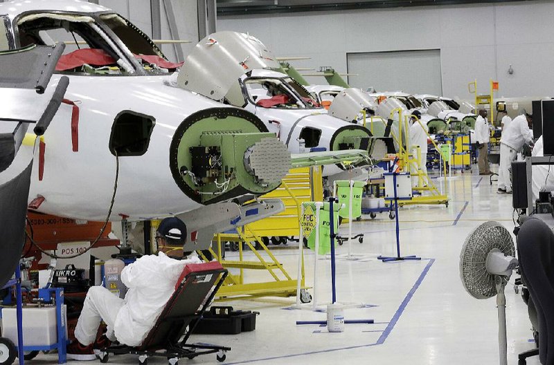 Employees work in the production area at Honda Aircraft Co. in Greensboro, N.C., earlier this year. U.S. manufacturing output dropped for the third straight month in October. 
