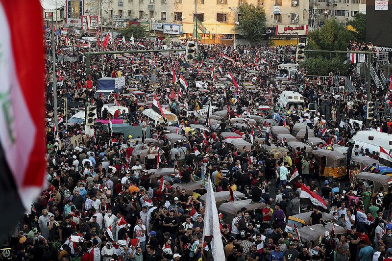 Anti-government protesters gather Friday in Baghdad’s Tahrir Square to demand changes to the country’s political system. 