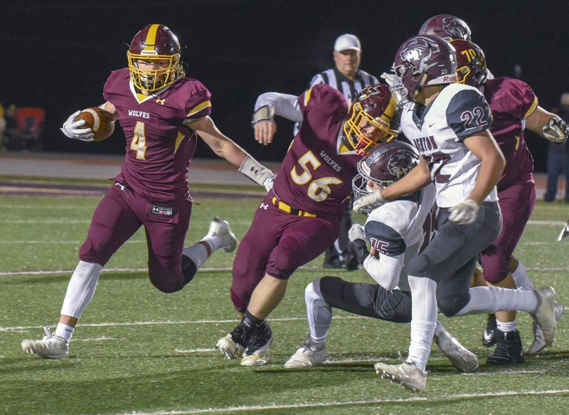 The Sentinel-Record/Grace Brown USING HIS BLOCK: Lake Hamilton running back Owen Miller (4) moves behind Jack Keeling (56) to pick up yards in Friday's loss to Benton at Bank OZK Field.