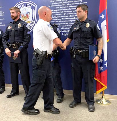 Submitted Photo. Capt. Derek Spicer (left), awards Officer Travis Luper with the Medal of Valor for his efforts in freeing a child from a submerged vehicle.