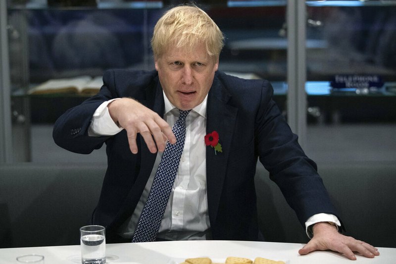 Britain's Prime Minister Boris Johnson gestures, during a visit to Metropolitan Police training college in Hendon, north London, Thursday, Oct. 31, 2019. (Aaron Chown/Pool Photo via AP)