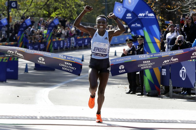 Joyciline Jepkosgei, of Kenya, crosses the finish line to win the Pro Women's Division of the New York City Marathon, in New York's Central Park, Sunday, Nov. 3, 2019.