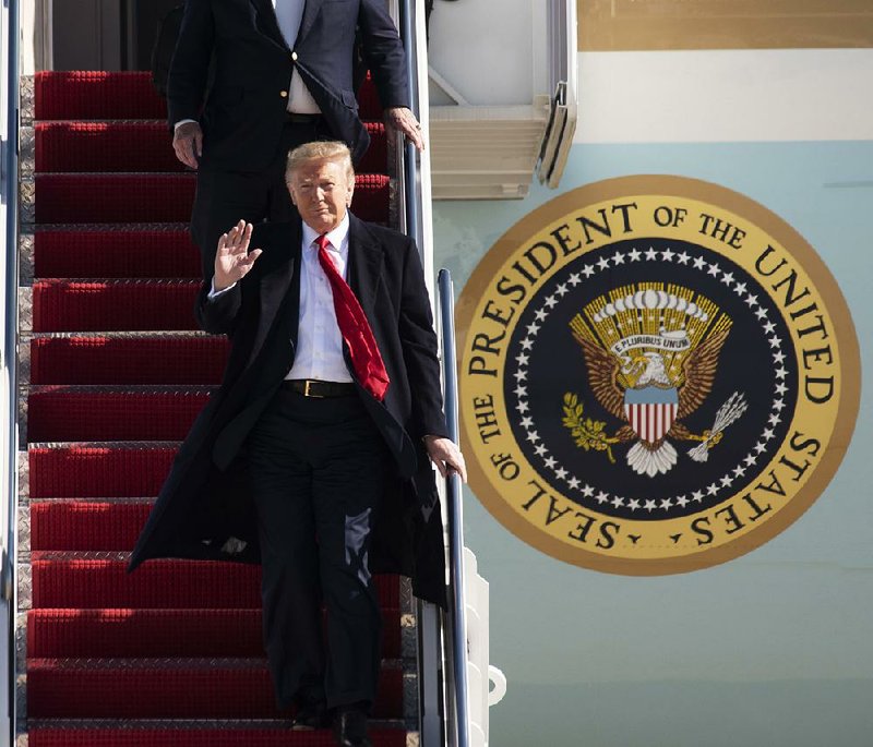 President Donald Trump disembarks from Air Force One on Sunday at Andrews Air Force Base in Maryland. Trump later pushed for the media to divulge the identity of the whistleblower, telling reporters at the White House that “you’d be doing the public a service if you did.” 