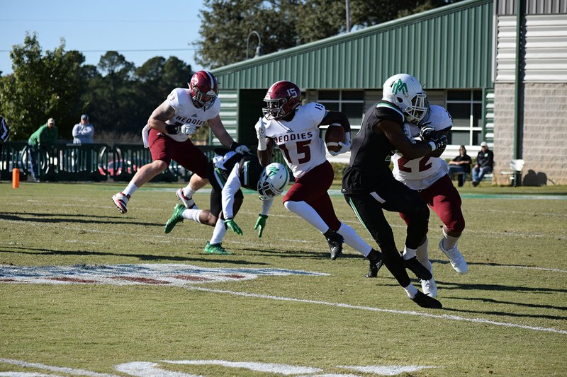 Henderson State receiver L'liott Curry (15) carries the ball in Saturday's 27-20 win over Arkansas-Monticello as teammates Logan Moragne (22) and Matt Tyler (23) block at Willis "Convoy" Cotton Boll Stadium in Monticello. Curry finished with 10 carries for 184 yards and two touchdowns. - Photo courtesy of HSU Athletic Department