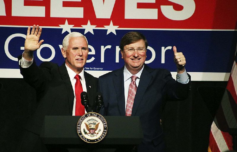 Vice President Mike Pence (left) and Republican gubernatorial candidate Tate Reeves acknowledge the crowd Monday at a rally in Biloxi, Miss.