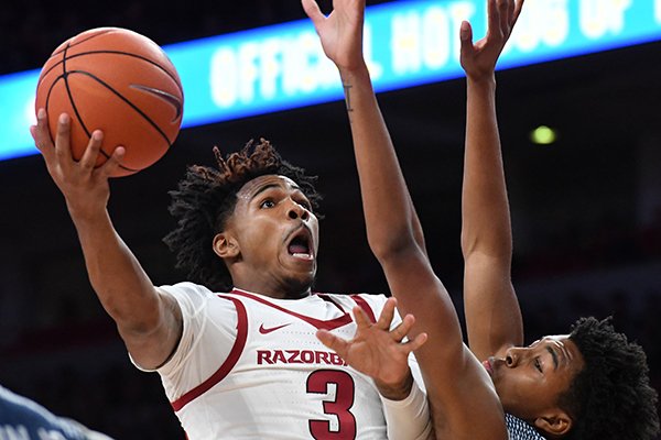 Arkansas guard Desi Sills goes up for a shot against Rice guard Trey Murphy during a game Tuesday, Nov. 5, 2019, in Fayetteville.