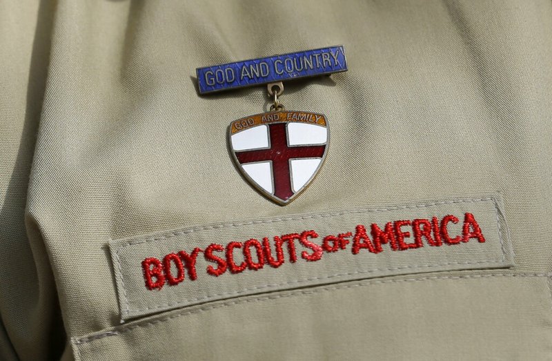 FILE - This Feb. 4, 2013 file photo shows a close up detail of a Boy Scout uniform worn during a news conference in front of the Boy Scouts of America headquarters in Irving, Texas. (AP Photo/Tony Gutierrez, File)