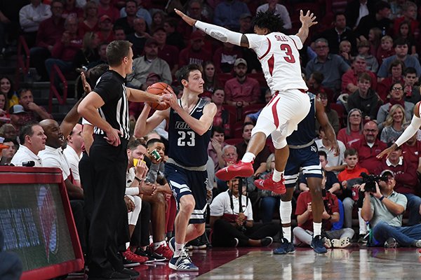 Arkansas guard Desi Sills (3) defends as Rice guard Drew Peterson (23) tries to inbound during a game Tuesday, Nov. 5, 2019, in Fayetteville.