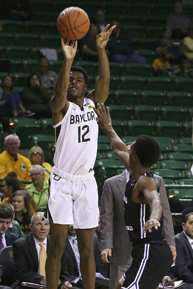 Baylor guard Jared Butler (12) shoots a three-pointer over Central Arkansas guard Lewis McDaniel on Tuesday during the second half of the No. 16 Bears’ 105-61 victory in Waco, Texas. Butler scored 30 points with a career-high eight three-pointers. 