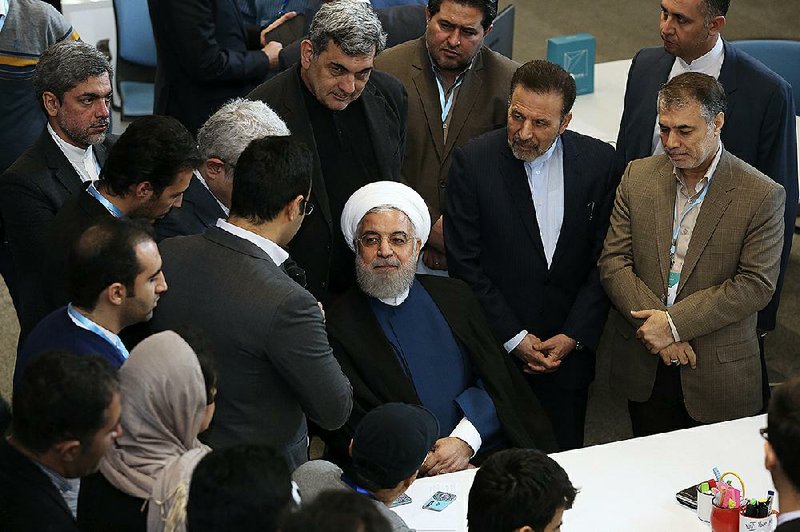 Iranian President Hassan Rouhani (center) attends a ceremony Tuesday to inaugurate the Azadi Innovation Factory in the Pardis technology park in Tehran. Rouhani also announced that Tehran will begin injecting uranium gas into 1,044 centrifuges.