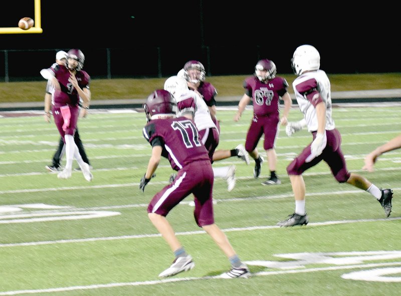 MARK HUMPHREY ENTERPRISE-LEADER Lincoln eighth grader Drew Moore tries to hit classmate Jace Birkes, playing receiver, during a Thursday, Oct. 17, 38-27, victory by the junior Wolves over Huntsville at Wolfpack Stadium.