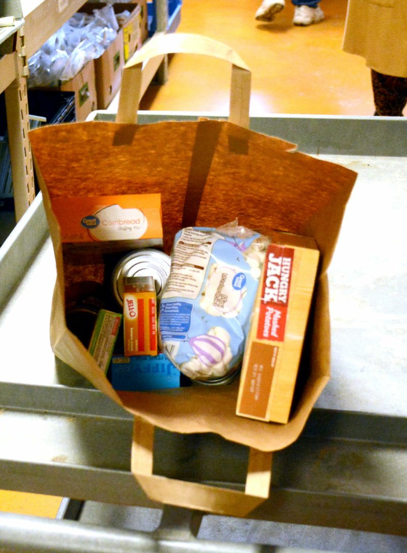 Marc Hayot/Herald-Leader Meal bags, like this one, are distributed to families in need so they will be able to have a Thanksgiving or Christmas meal.