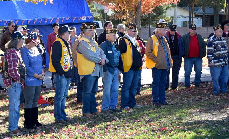 Westside Eagle Observer/MIKE ECKELS Several Korean, Vietnam, Desert Storm and Iraqi Freedom veterans gather around the Howard-Parrish VFW Post 9834 memorial to remember all of their fallen commands during the fourth annual Veterans Day commemoration ceremony at Veterans Park in Decatur on Saturday.