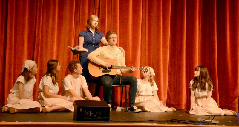 Marc Hayot/Herald Leader Sierra Horner (left), Kate Kelley, Reece Edwards, Isabelle Pennick, Lindsey Bolstad, and Emma Bryant listen as Clayton Hoskins plays the guitar during a practice for the Siloam Springs High School's production of The Sound of Music. 