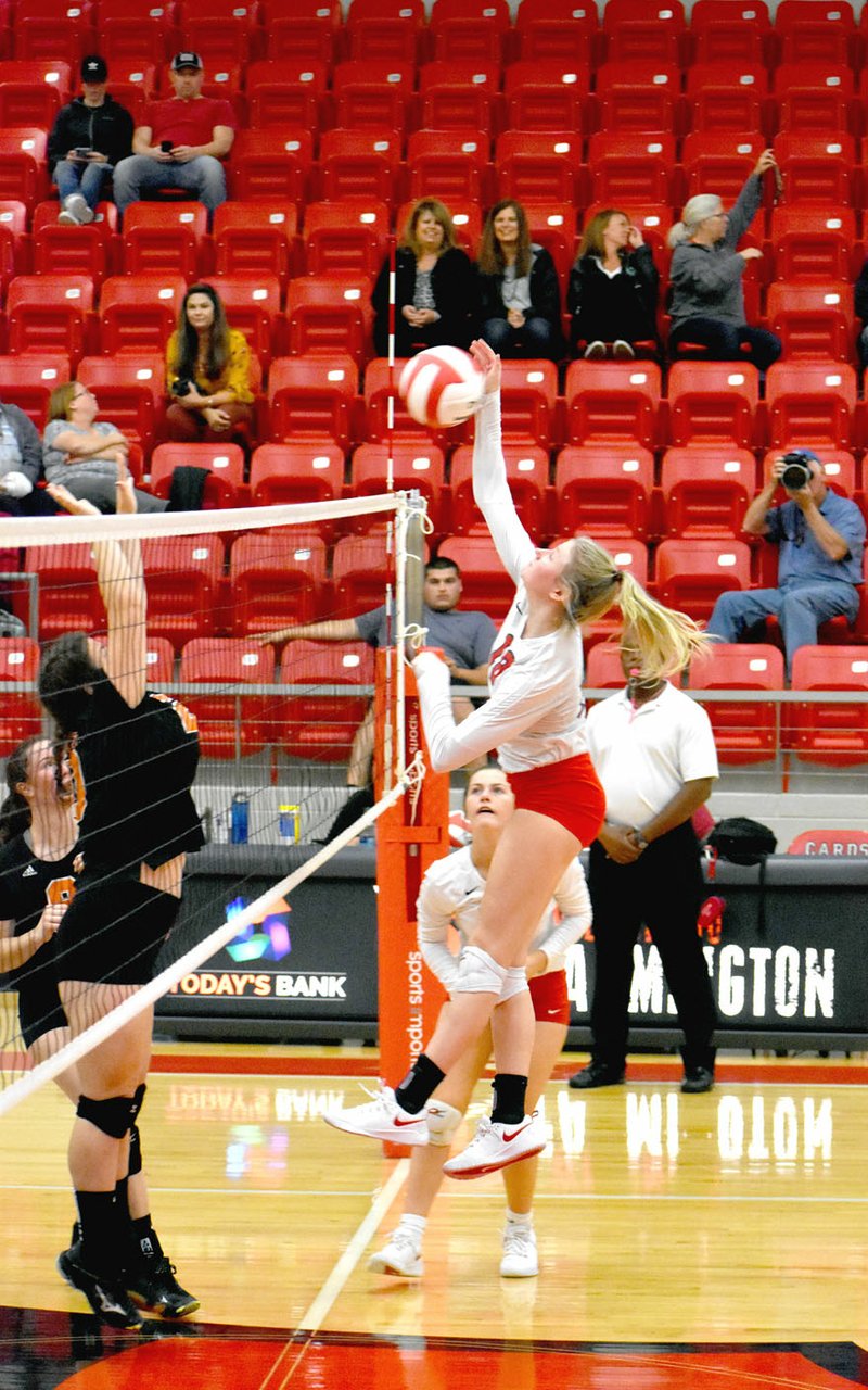 MARK HUMPHREY ENTERPRISE-LEADER Farmington senior Brittany Pittman smashes a kill over the net past an attempted Gravette block. Farmington took Gravette in three sets, 25-14, 25-18, 25-18, on Thursday at Cardinal Arena to maintain first place in the conference standings. The Lady Cardinals were 17-3-1 overall and 10-0 in the 4A-1 coming into the last week of regular season play.