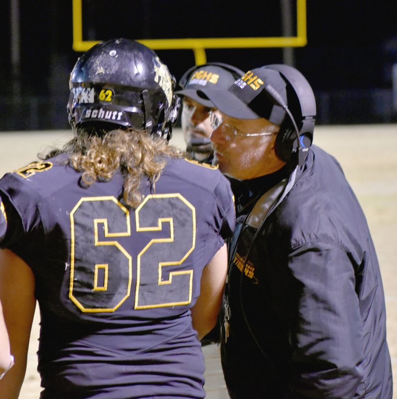 MARK HUMPHREY ENTERPRISE-LEADER Prairie Grove football coach Danny Abshier, shown talking to senior lineman Austin Medina, is two wins away from obtaining 200 career Arkansas high school football victories coming into week 10 of the regular season. The Tigers defeated Berryville, 46-21, last week to move Abshier up to 198 wins.