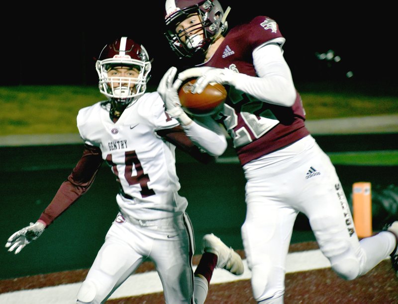 MARK HUMPHREY ENTERPRISE-LEADER Lincoln senior Blake Arnold catches a pass in front of Gentry defensive back Isaiah Lopez. Arnold had receptions of 19, 16, 6 and an 8-yard touchdown catch. The Wolves lost 34-13 to the Pioneers. Lincoln goes to Prairie Grove Friday to finish out the regular season. The Wolves (5-4, 2-4 4A-1) need a victory to accomplish their first back-to-back winning seasons in school history. Last season Lincoln went 8-3.