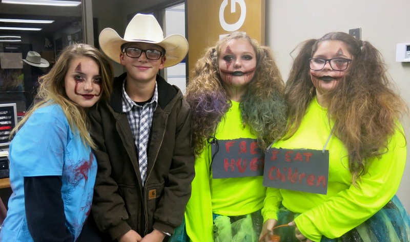 Westside Eagle Observer/SUSAN HOLLAND Four teenagers from Maysville, Lexcey Boyle, 17; Garrett Harris, 13; Harlee Harris, 15; and Kayley Andrews, 14, enjoy the trick or treat at the fire station Thursday night, Oct. 31. The event, sponsored by the Gravette Police Department and the Gravette Fire Department, was attended by many youngsters and adults as well as several teens.