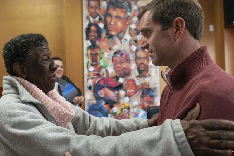 Kentucky Attorney General and Democratic gubernatorial candidate Andy Beshear speaks with Maddie Jones, of West Louisville, during a campaign stop at Southern Hospitality, Tuesday, Nov. 5, 2019, in Louisville, Ky. (AP Photo/Bryan Woolston)