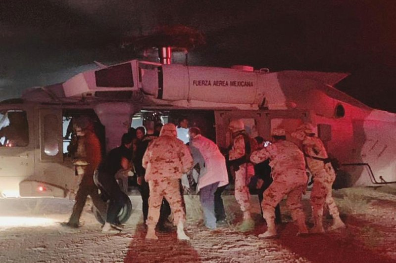 Children injured in an ambush on a family in a remote, mountainous area of northern Mexico are loaded onto a Mexican air force helicopter late Monday. More photos at arkansasonline.com/116killings/ 