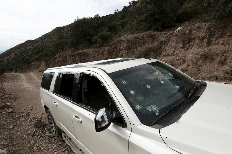 This bullet-riddled vehicle that held members of the LeBaron family sits on a dirt road Wednesday near Bavispe, at the Sonora-Chihuahua border in Mexico. 